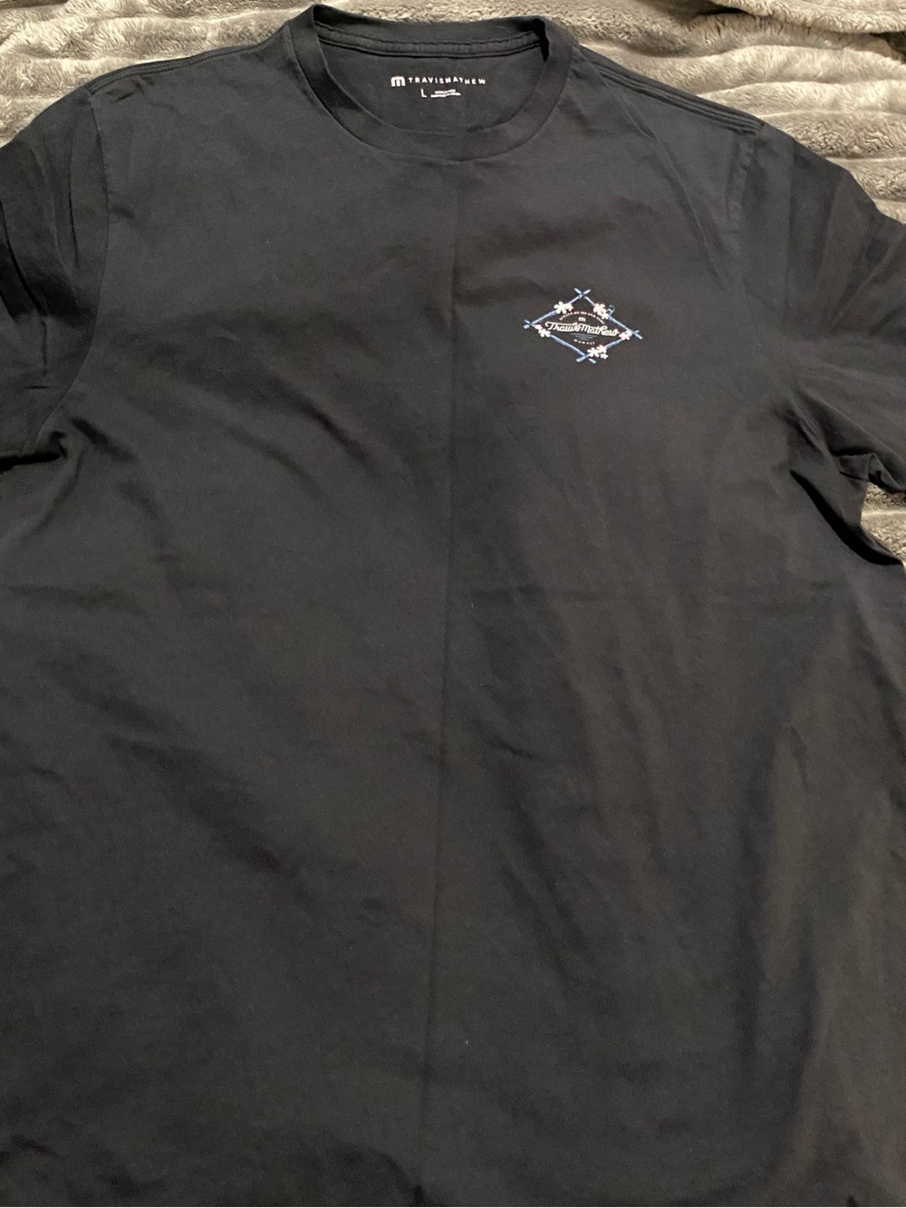 Travis Mathew Black Short-Sleeve Tee with Small Blue & White Chest Graphic